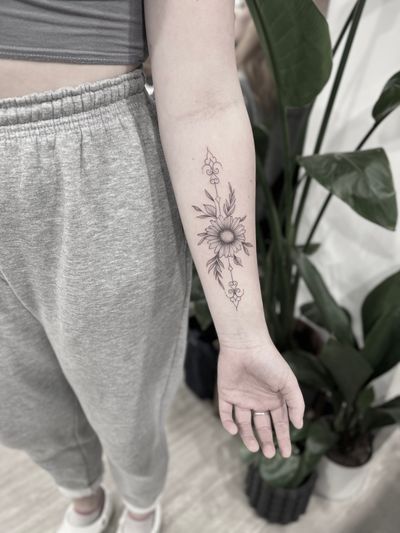 Embrace the beauty of nature with this delicate sunflower design by Aleks Fanta. Perfect for lovers of floral and ornamental tattoos.