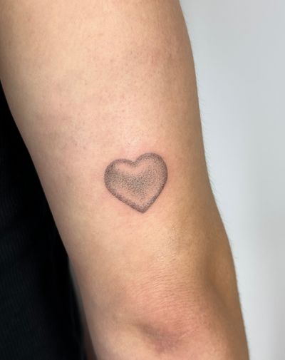 Unique dotwork and hand-poke techniques bring this micro realism heart tattoo to life. Expertly crafted by Alina Wiltshire.