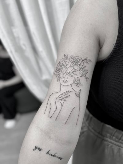 Experience the beauty of nature with this delicate fine line illustration of a woman, brought to life by tattoo artist Aleks Fanta.
