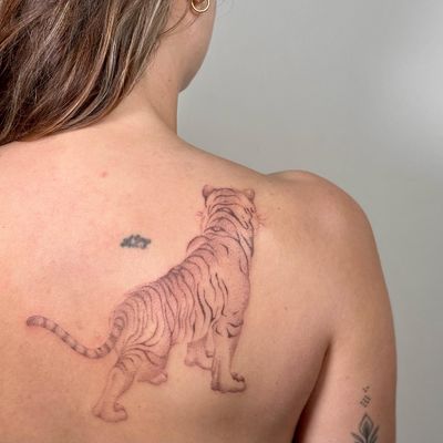 Experience the unique artistry of hand-poked dotwork in this captivating tiger motif by Alina Wiltshire.