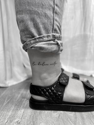 Small lettering tattoo design created by tattoo artist Aleks Fanta in a sleek fine line style. Perfect for a subtle and elegant look.