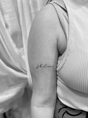 Elegantly crafted small lettering tattoo by Aleks Fanta, showcasing intricate detail and minimalistic design.