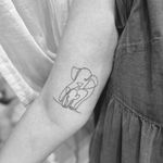 Get inked with a delicate single-line elephant design by Aleks Fanta. Perfect for those who appreciate simplicity in their body art.