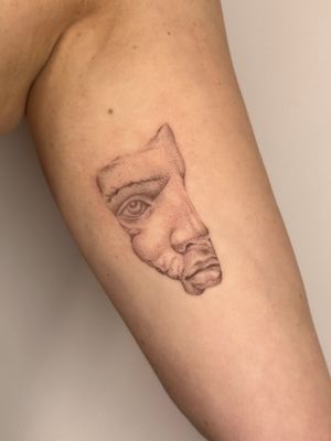 Unique dotwork & hand poke tattoo by Alina Wiltshire, capturing the intricate details of a stunning statue face.