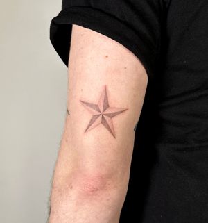 Unique dotwork hand poke tattoo of a naval star by Alina Wiltshire, combining precision and minimalism.