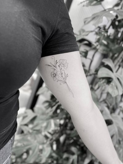 Beautiful and intricate fine line tattoo of a delicate flower, done by tattoo artist Aleks Fanta.