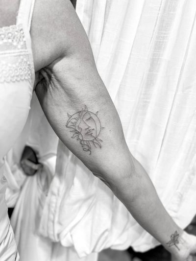 Elegant and intricate sun and moon design in one delicate single line, expertly inked by artist Aleks Fanta.