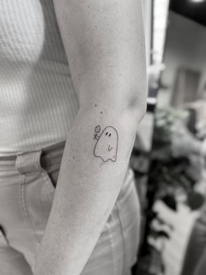 This fine line tattoo by Aleks Fanta features a delicate and spooky ghost motif, perfect for those seeking a subtle and elegant design.