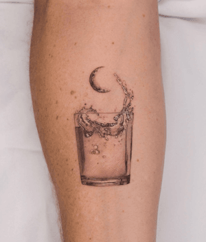 surreal water glass with moon tattoo