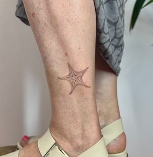 Hand-poked by Alina Wiltshire, this stunning tattoo captures the beauty of a starfish with intricate dotwork details.