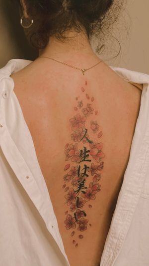 Japanese script, kanji and fine line red cherry blossoms on the spine