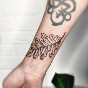 Capture the beauty of nature with this illustrative leaf tattoo crafted by the talented artist Michelle Harrison.