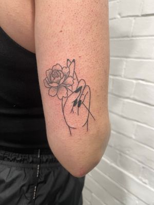 Unique hand-poked dotwork design featuring a beautiful flower motif, created by talented artist Marketa_handpoke.