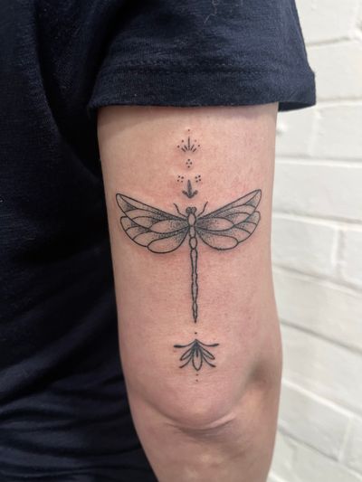 Unique dotwork dragonfly tattoo created by Marketa.handpoke with a hand poke technique for a one-of-a-kind look.