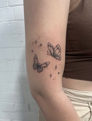 Elegant dotwork and fine line butterfly tattoo done by hand-poke technique, created by the talented artist Marketa.