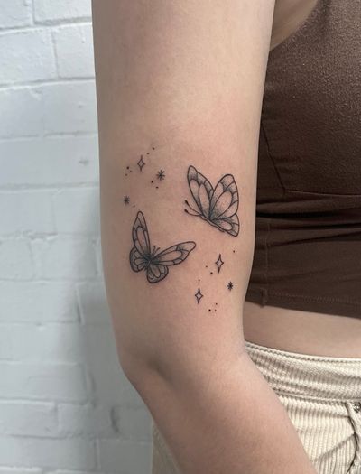 Elegant dotwork and fine line butterfly tattoo done by hand-poke technique, created by the talented artist Marketa.