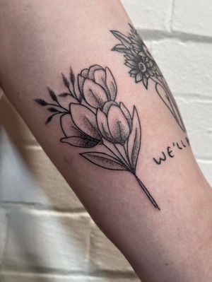 Unique dotwork hand-poked tulip design by Marketa.handpoke. A delicate and intricate floral tattoo.