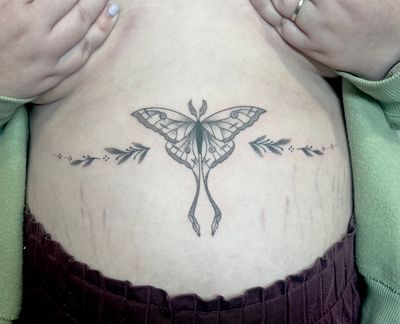 Delicate hand-poked moth tattoo in dotwork style by Marketa.handpoke. Unique and intricate design.