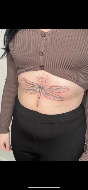 Experience the beauty of a hand-poked dotwork dragonfly tattoo by Marketa.handpoke.
