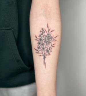 Admire the delicate artistry of this intricate hand-poked dotwork floral bouquet by Marketa.handpoke.