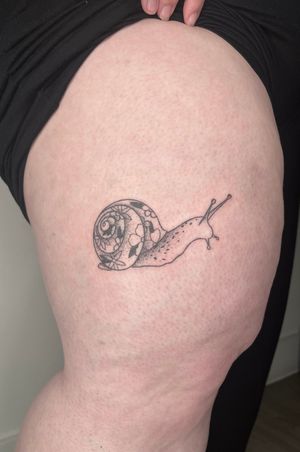 Hand-poked tattoo of a intricate dotwork snail design by Marketa.handpoke.