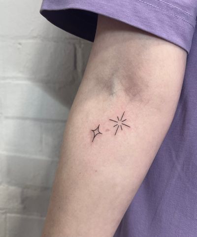 Embrace the simplicity of a fine line handpoked star tattoo by the talented artist Marketa. Exquisite and elegant.