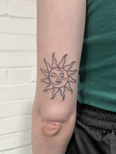 Experience the beauty of the sun and moon in this intricate dotwork hand poke tattoo by Marketa.handpoke.