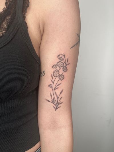 Elegant and delicate flower design hand-poked by Marketa, using intricate dotwork technique for a unique tattoo experience.