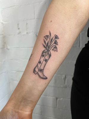 Get a unique and intricate boot tattoo done in dotwork style by the talented hand-poke artist Marketa. Embrace the art of hand-poked tattoos with this one of a kind design.