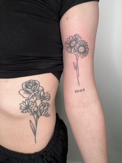 Beautiful floral design by Marketa.handpoke, using delicate dotwork technique for a unique and intricate look.