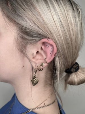 Beautiful ornamental ear design by Marketa.handpoke, created with intricate dotwork technique.