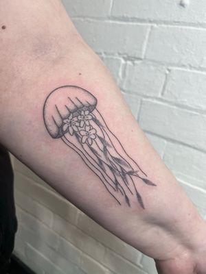 Get lost in the intricate beauty of this jellyfish design hand poked by Marketa.handpoke. Unique, hypnotic, and timeless.