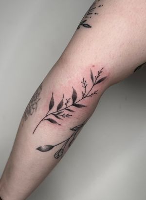 Experience the intricate beauty of a hand-poked fine line dotwork branch tattoo by the talented artist Marketa. A stunning piece of nature-inspired art for you.