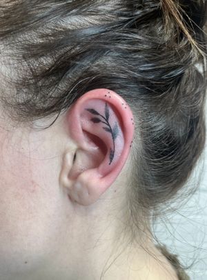 Intricately designed ornamental dotwork tattoo on ear, by artist Marketa.handpoke. Exquisite and elegant.