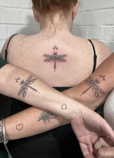 Get a stunning illustrative dragonfly tattoo done by Marketa.handpoke for a unique and artistic body art experience.