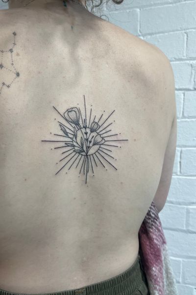 A beautifully detailed dotwork and fine line hand-poked tattoo of a sunflower by artist Marketa.handpoke.