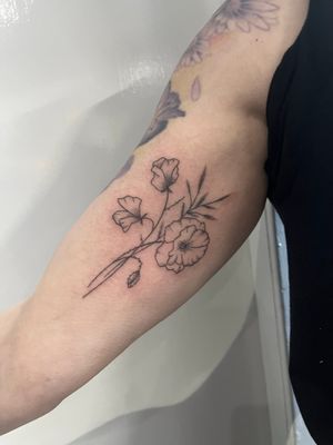 Experience the beauty of hand-poked dotwork with this delicate fine line flower tattoo by Marketa.handpoke. Perfect for a subtle and sophisticated look.