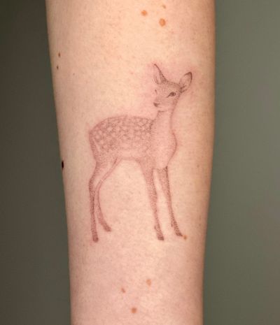 Hand-poked micro-realism tattoo of a deer inspired by Bambi, created by artist Alina Wiltshire.