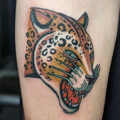 Get a fierce and timeless traditional leopard tattoo by the talented artist Benji Charnock.