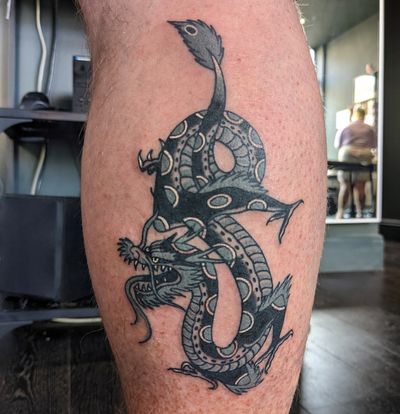 Experience the ancient power of a traditional dragon tattoo by the skilled hands of Benji Charnock. A symbol of strength and protection.
