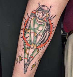 Unique traditional tattoo featuring an astronaut woman by Benji Charnock. Perfect blend of art and science fiction.