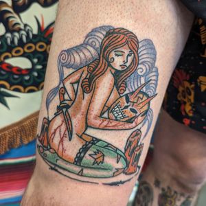 Classic pin up girl tattoo with vibrant colors, bold lines, and expert shading. Experience the timeless artistry of Benji Charnock.
