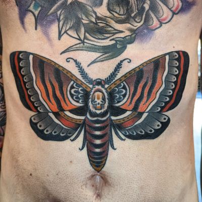 Experience the timeless beauty of a traditional moth tattoo crafted by the talented Benji Charnock. Let this stunning design symbolize transformation and resilience. Book your appointment today!