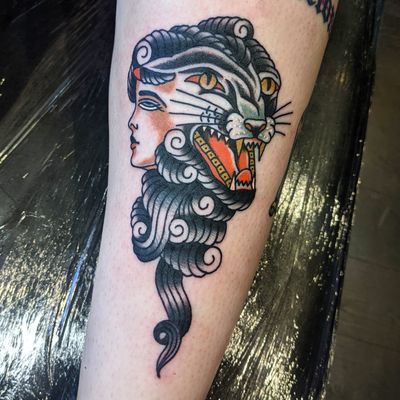Intricate traditional tattoo featuring a fierce panther and a captivating woman, beautifully executed by Benji Charnock.