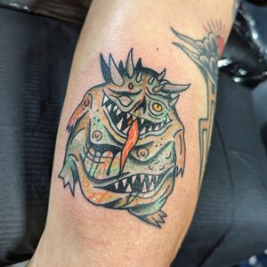 Get a fierce and bold traditional monster tattoo by the talented artist Benji Charnock. This design is perfect for those who love classic tattoo styles with a touch of horror.