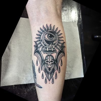 Experience the timeless beauty of traditional tattoo art with this stunning design featuring a sun, moon, and bat by the talented artist Benji Charnock.