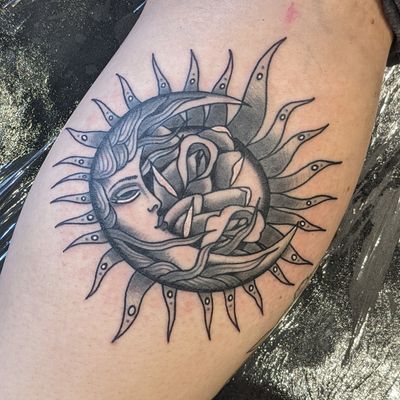 Celestial elements of sun and moon intertwined with a delicate rose design, by Benji Charnock.