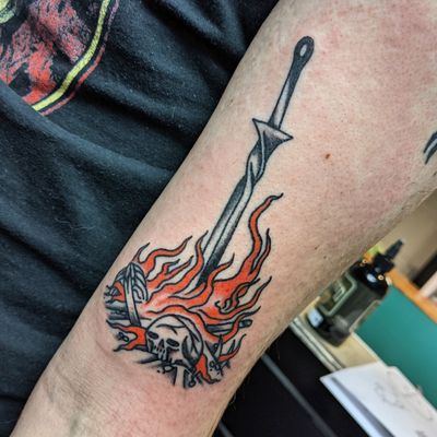 Embrace the power and bravery with this traditional sword tattoo by the talented Benji Charnock. A timeless symbol of strength and honor.