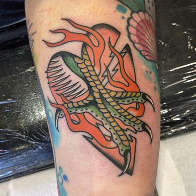 Experience the fierce beauty of a traditional dragon tattoo expertly done by renowned artist Benji Charnock.