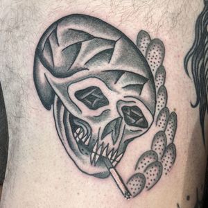 Experience the timeless artistry of traditional tattooing with this striking skull design by renowned artist Benji Charnock.